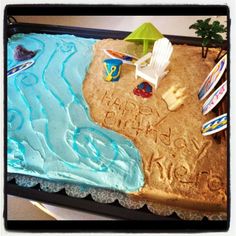 a birthday cake that is shaped like the beach