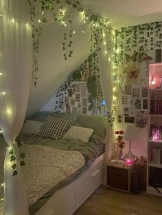 a bedroom decorated in white and green with fairy lights on the wall above the bed