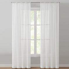 a white curtain hanging in front of a window