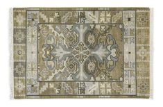 a rug with an intricate design on the front and back side, in beige tones