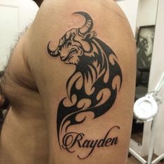 a man with a tattoo on his arm that says rayden and an image of a bull