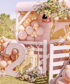 a pink and white horse themed birthday party with balloons, flowers, cake and decorations