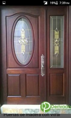 a wooden door with glass panels on the front and side doors in dark wood color