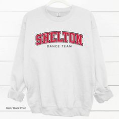 Shelton Dance Team Shirt If you’re the school spirit type, this Shelton High School Dance Team Shirt is for you! Get ready to show your SHS pride with this comfortable and stylish shirt, perfect for cheering on your favorite dance squad. Go Climbers!! Choose T-shirt, Crewneck Sweatshirt or Hoodie Sweatshirt. Super comfy unisex sizes. Our shirts, hoodies, and sweatshirts are crafted with comfort and quality in mind. Made from premium materials, they are soft, durable, and perfect for everyday wea Sporty Tops For School Sports Season, School Spirit Stretch Tops For Cheerleading, Sporty Cheerleading Tops With Name Print, Sporty Letter Print Tops For College Events, Sporty Tops With Letter Print For College Events, Sporty Stretch Tops For School, Varsity Tops With Team Name For College Events, Sporty Tops With Team Name For College Events, Sporty Long Sleeve Tops For College Events