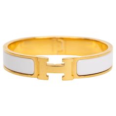 The Hermes Clic Clac H, narrow bracelet in white enamel with gold-plated hardware. Size PM, new in unworn condition, comes with velvet pouch. Modern White Bangle For Formal Occasion, Designer Adjustable White Bracelets, White Bangle Cuff Bracelet For Formal Occasions, Formal White Cuff Bangle Bracelet, Classic Gold-tone Bracelets For Formal Occasions, Timeless Formal Gold Bracelets, Formal White Bangle Cuff Bracelet, Classic Formal Bracelets With Gold-tone Hardware, Timeless Formal Bracelets With Gold-tone Hardware