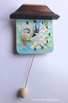 a clock with a bird painted on it