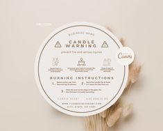 the label for candle warning is displayed on a round white sticker with dried grass