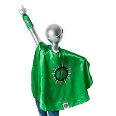 a person wearing a green cape and holding a metal object in the air with one hand