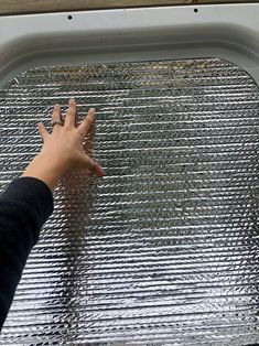 a person's hand on the window sill of a vehicle with condensation