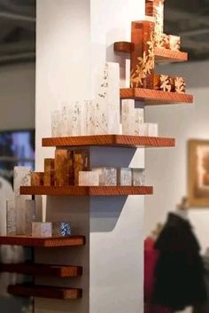 two wooden shelves with candles on them in a room