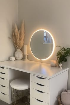 a white desk with a round mirror on it