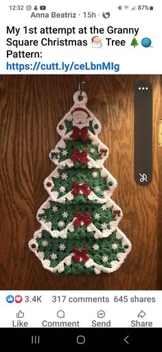 a crocheted christmas tree hanging on a wall