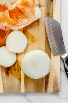 an onion and onions on a cutting board next to a knife