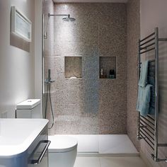 a bathroom with a toilet, sink and shower in it's center wall area