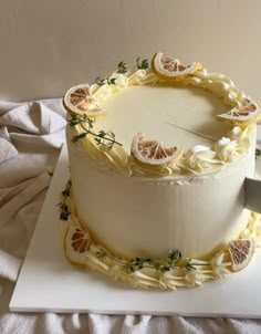 a white cake with orange slices on it