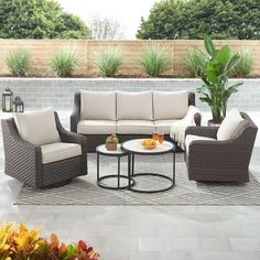 an outdoor patio with furniture and potted plants