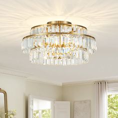 a chandelier hanging from the ceiling in a living room