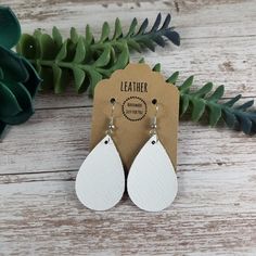 "These mini white teardrop petal leather earrings make a great statement, yet simple and easy for everyday wear.  They feature a shiny line texture to them and are lightweight and sure to pair perfectly with any outfit!  They also make great gifts for moms, daughters, grandmothers, sisters, friends, teachers, coworkers, and more! *Size = Mini = 1.5\" long x 1\" wide with a drop length of 2\" *last photo shows other styles and sizes listed elsewhere in the store - these are the Mini Teardrop* *Thickness = 1.0mm = average* > Durable > Noise free > Affordable > Nickel free fishhook ear wire > Rubber backs included so you can wear them without losing one! I have a variety of colors and styles to choose from so be sure to view my other listings: https://bethwolfhandmade.etsy.com All items are m Gifts For Moms, Leather Earring, Line Texture, Earrings Summer, Great Gifts For Mom, White Earrings, Light Weight Earrings, Summer Jewelry, Leather Earrings