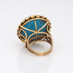 Finely detailed vintage micro mosaic cocktail ring crafted in 14 karat yellow gold.   Tiny tiles of small coloured glass form the image of a bird in full flight (we believe the bird is a dove), set flush into a blue stone mount. Micro mosaic jewellery has been popular since the initial Egyptian Revival period of the early 1800s. This ring was made much later in approx. the 1960s and is a testament to the popularity of micro mosaic jewellery. The techniques used to hand set the micro mosaic is an Antique Yellow Gold Turquoise Cabochon Ring, Vintage Gold Turquoise Ring For Formal Events, Gold Vintage Turquoise Ring For Formal Events, Gold Vintage Turquoise Ring For Formal Occasions, Vintage Gold Turquoise Ring For Formal Occasions, Antique Yellow Gold Turquoise Ring Gift, Antique Turquoise Ring In Yellow Gold, Antique Turquoise Ring In Yellow Gold For Gift, Tiny Tiles