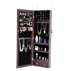 an open wooden jewelry cabinet with many necklaces