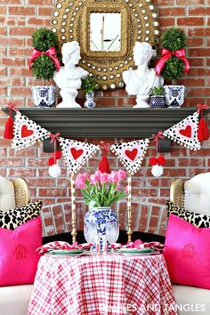 a red and white valentine's day table setting in front of a brick wall