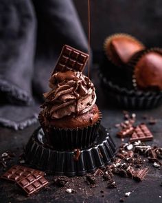 two chocolate cupcakes on top of each other