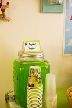 there is a green mason jar with a name tag on it next to other items