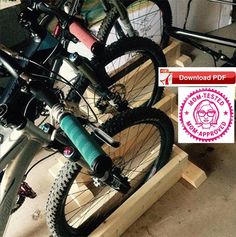 there are two bikes that are sitting on the rack in the shop, one is blue and the other is pink