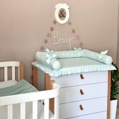 a baby's room with a crib and dresser