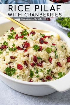 rice pilaf with cranberries and parsley in a white serving dish