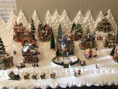 a christmas village is displayed on a table