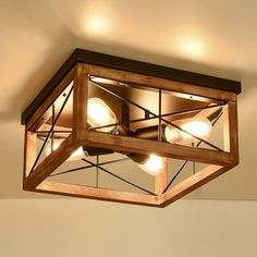 a wooden light fixture hanging from the ceiling