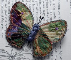 a close up of a butterfly on top of an open book