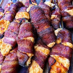 several skewered meats are sitting on a cutting board