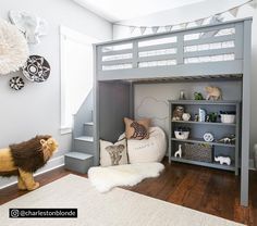 a loft bed is in the middle of a room with white walls and wooden floors