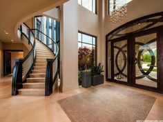 a large foyer with glass doors and chandelier