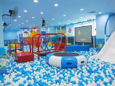 an indoor play area with blue and white balls