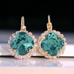 Sparkly, eye-catching, green crystal earrings will brighten up any outfit! Precision-cut crystals and unmatched, gorgeous colors are always show-stoppers! Details: * Premium European Crystals in Setting- 3/4"(18mm) * 14k Gold-Plated Lever Back Earrings * Earring Length- 1"(25mm) * Nickel and Lead-free These earrings come in a jewelry bag and box with ribbon. Elegant Green Crystal Earrings With Ear Wire, Green Round Crystal Earrings For Formal Occasions, Green Sparkling Stone Earrings For Gift, Green Crystal Earrings For May Birthstone Anniversary, May Birthstone Crystal Drop Earrings, Emerald Drop Crystal Earrings, Green Crystal Wedding Earrings With Ear Wire, Green Crystal Drop Earrings For Formal Occasions, Green Crystal Drop Earrings