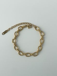 We love this bracelet as a set with our Oval Link Necklace, but this can easily transition into your current everyday stack. This bracelet adds a formal, chic touch to any outfit. 18K gold plating on stainless steel Oversized oval link chain 6.75" chain with 2" extender Water resistant, hypoallergenic Chic Paperclip Bracelet With Adjustable Oval Link, Chic Gold Chain Paperclip Bracelet With Oval Links, Chic Oval Link Paperclip Bracelet, Metal Charm Bracelet With Tarnish-resistant Rectangular Links, Everyday Gold-tone Oval Link Bracelet, Chic Oval Metal Jewelry, Adjustable Gold-tone Stainless Steel Chain Bracelet, Minimalist Metal Chain Bracelet With Oval Links, Gold-tone Adjustable Chain Stainless Steel Bracelet