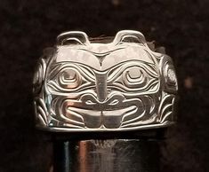 On offer is a West Coast Namgis First Nation Hand Carved Sterling Silver ''Beaver'' ring. by World renowned master carver Joe R. Wilson with his depiction of Beaver in the style of the Namgis, Kwakuitl First Nation. Initialed by Joe. Fine example of Indigenous Art from the Northwest Coast First Nations of Canada. PLEASE NOTE THAT THIS IS A CUSTOM RECREATED HAND CARVED ITEM THAT WILL HAVE SLIGHT, SUBTLE DIFFERENCES THAT ARE VERY HARD TO DISTINGUISH WHEN COMPLETED FROM THE PICTURES SHOWN ABOVE! DO NOT PURCHASE IF YOU HAVE AN ISSUE WITH THIS AND ALL CUSTOM PIECES WHEN DONE ARE CONSIDERED FINAL SALE WITH A NO RETURN POLICY. Allow for 20 - 40 day's handling time on all of Joe's items If you wish to have Joe engrave a name or initials on the back of this item at no extra charge, please provide c Beaver Spirit Animal, Boar Tusk Jewelry, Inuit Jewelry, Beaver Wood Carving, Winter Ceremony, Beavers Bend, Getting To Know Someone, Northwest Coast, Indigenous Art