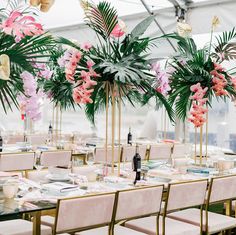 tables set up with pink chairs and centerpieces