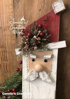 a wooden sign with a man's face on it and pine cones in the corner