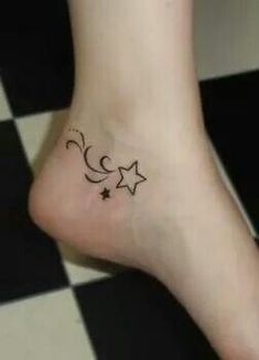 a small star and crescent tattoo on the left side of the foot, which is drawn in black ink