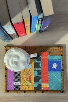 a table topped with books next to a cup of yogurt