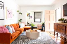 a living room filled with furniture and a flat screen tv on top of a wooden dresser