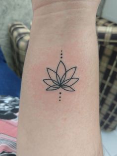 a black and white photo of a lotus flower on the left arm, with dots in it