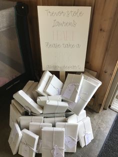 a pile of white boxes sitting next to a sign