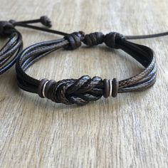 "These lovely bracelets are made with waxed cord, brown rubber spacers, and sterling silver links. Designed for couples If you choose \"Custom Initials Set\" Please leave me a note at checkout with the initials. Both bracelets are adjustable. One closes to 6\" and opens to 9\", the other closes around 7\" and opens to 10\". Includes Gift Box if you choose the set option in the dropdown menu." Personalized Adjustable Beaded Bracelets For Promise, Brown Resizable Jewelry For Gifts, Brown Adjustable Band Bracelet Jewelry, Adjustable Silver Wristband For Anniversary, Handmade Adjustable Bracelets For Anniversary, Personalized Brown Bracelet Jewelry, Adjustable Brown Jewelry For Friendship, Brown Charm Bracelet Gift, Adjustable Handmade Friendship Bracelets For Promise