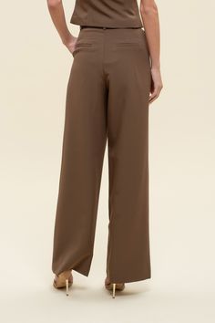 Office chic to date night to weekends looking cutie while on-the go, dress to impress in our Greenwich pleat trousers. These high-waisted pants feature a hook and eye closure, belt loops, back pockets, slick side pockets, pleated detailing, a wide leg with a flared hemline, and let's not forget they are the color of the season - chocolate BROWN! Designed in the USA. Imported Fabric Content: 88% Polyester, 12% Spandex. Inner Lining: 100% Polyester Model is 5'6 and is wearing a size Small. Elegant Brown Pleated Bottoms, Brown Stretch Pleated Bottoms, Brown Wide-leg Dress Pants With Belt Loops, Brown High-waisted Pants With Welt Pockets, Brown Pleated Wide-leg Bottoms, Pleated Trousers, Chic Office, Loungewear Women, Active Women