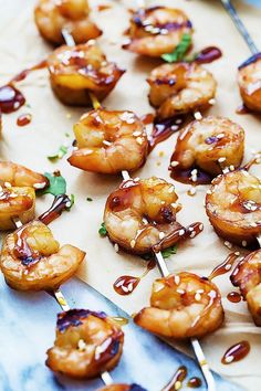 shrimp skewers with teriyaki sauce on a sheet of waxed paper